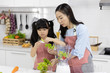 © xreflex - Happy Asian family in the kitchen. Mother and  Little girl are preparing the salad in blender Menu tasty smoothie and ingredients on table at home. Cooking food, Healthy food concept