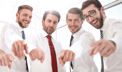 Wall Mural - successful business team standing in the office and pointing at you