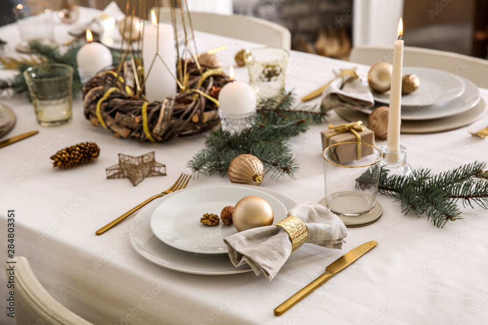 Beautiful table setting with Christmas decorations in living room - obrazy, fototapety, plakaty 