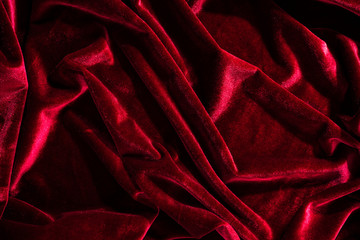 Background image of crumpled fabric. Red velvet