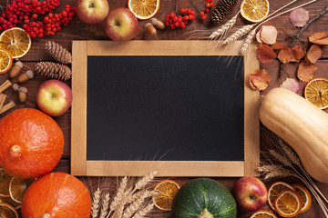 Thanksgiving of harvest fest autumn wooden background with chalkboard