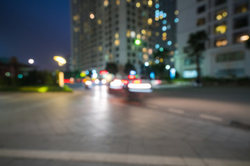 Blurred modern urban city at night with street traffic