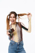 © Drobot Dean - Portrait of cheerful young woman wearing headphones smiling and holding retro camera