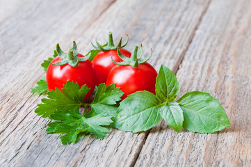 Wall Mural - Fresh cherry tomatoes on old wooden table