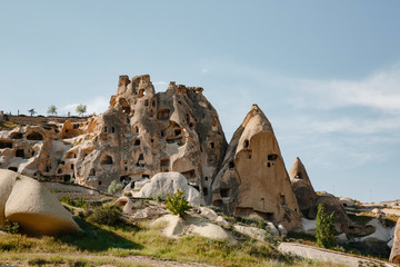 Wall Mural - Carved houses in rock in Pigeon Valley, Uchisar, Cappadocia, Turkey