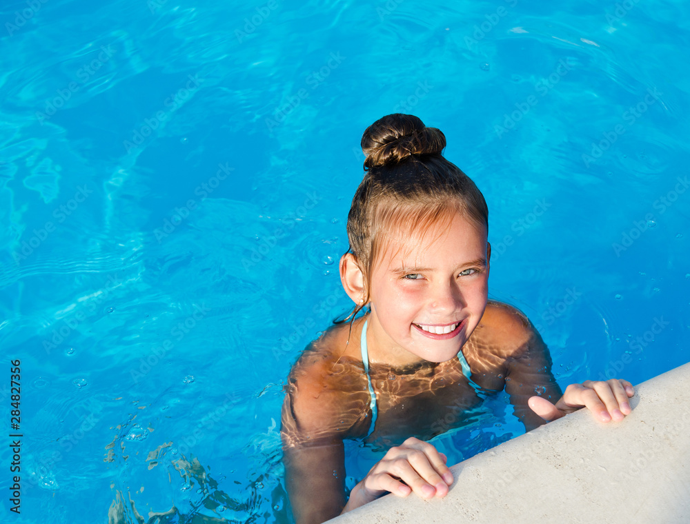 Cute smiling little girl child having fun in the swimming pool Stock ...