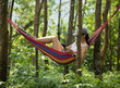 © lzf - Relaxing in hammock,using smartphone in tropical rainforest