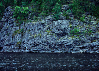 Wall Mural - Blue rocky sea shore. Background for travel and adventure materials.