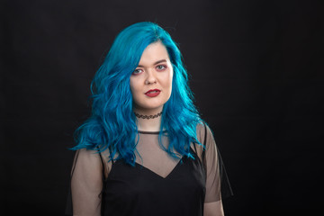 Wall Mural - Sryle and fashion concept - Close up portrait of woman with blue long hair over black background