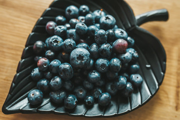 Delicious blueberries on a heart shaped plate.