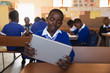 © Wavebreak Media - Schoolboy using tablet in a lesson at a township school