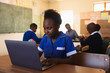 © Wavebreak Media - Schoolgirl using laptop in a lesson at a township school
