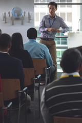 Wall Mural - Young male speaker speaks in a business seminar