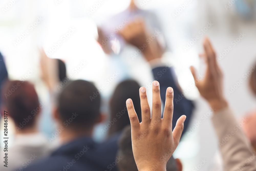 Hands raised in a business seminar - obrazy, fototapety, plakaty 