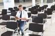 © WavebreakMediaMicro - Male doctor sitting on chair and using digital tablet in conference room