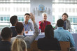 © wavebreak3 - Businesswoman raising hand in a business seminar