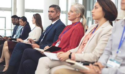 Wall Mural - Side view of business people attending a business seminar