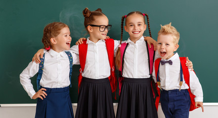 Wall Mural - funny group children  student boy  and girl about school blackboard