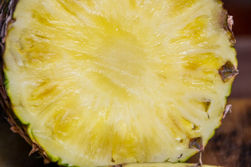 Ripe pineapple and pineapple slices on a wooden background tropical fruits