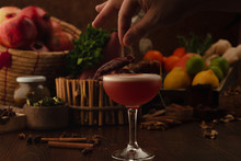 Beautiful Cocktail In The Chalet On A Wooden Background. Background Decorated With Fruits And Herbs.
