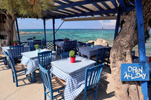 Typical Blue Furniture Greek Taverna By A Turquoise Aegean Sea, Agios Prokopios, Naxos, Greek Islands