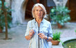 © JENOCHE - Attractive middle-aged blond woman et street.