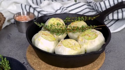 Sticker - Raw garlic heads with fresh spices in cast iron skillet for preparing roasted garlic recipe.