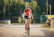 © nuclear_lily - Picture of young woman in helmet on bike ride on summer day