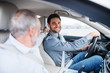 © Halfpoint - Father and son sitting in car, driving and talking.