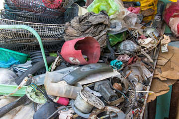 A pile of parts, equipments and old things in the backyard. Used components for appliance replacement and repair.