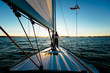 © Tandem Stock - Rear view of woman standing on yacht at sunset