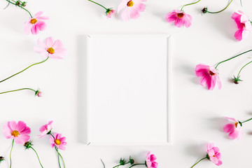 beautiful flowers composition. blank photo frame, pink cosmos flowers on white background. flat lay,