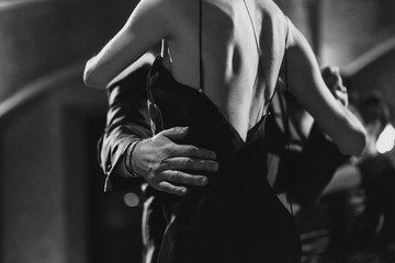 A man and a woman dancing tango. Black and white image