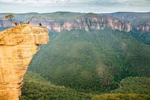 Woman Sitting On Top Of Cliff At Hanging Rock