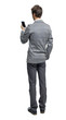 © ghoststone - Back view of a businessman who is looking into the smartphone.