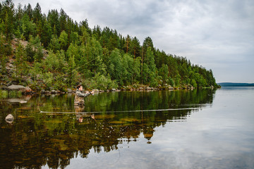 Wall Mural - Fisherman using rod fly fishing in mountain river