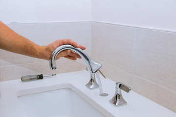 Wall Mural - Repair service, assemble new faucet lies on the ceramic sink