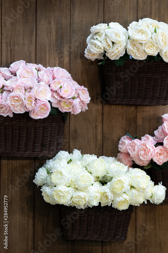 Wicker rattan baskets full of pink and white roses