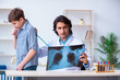 © Elnur - Male radiologist looking at boy's images
