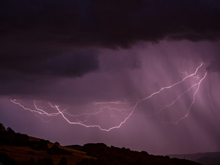 Storm with lightning over hilly landscape - Long exposure at night