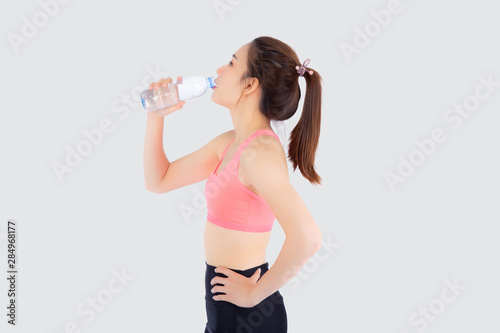 Cuadros en Lienzo Beautiful young asian woman fit shape drinking water after workout and exercise isolated on white background, girl thirsty after aerobic tired for refresh, model fitness healthy and wellness concept