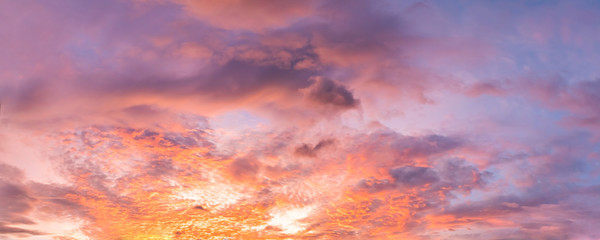 Wall Mural - Dramatic vibrant color with beautiful cloud of sunrise and sunset on a cloudy day. Panoramic image.