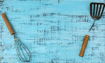 Wall Mural - Vintage old kitchen utensils on a blue wooden background.