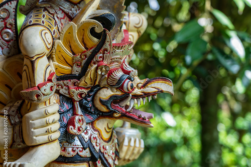 Cuadros en Lienzo Balinese ancient colorful bird god Garuda with wings, closeup