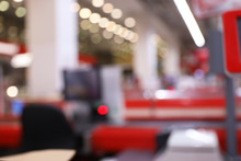 Blurred View Of Checkout Lanes In Supermarket With Bokeh Effect