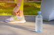 © fotofabrika - Woman runner tying her shoes laces preparing for a morning run
