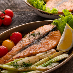 Wall Mural - Salmon steak with baked tomatoes and celery. Fish with vegetables.