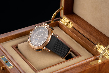 wrist watch packed in open wooden box. roman dial