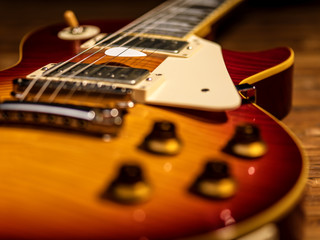 Wall Mural - electric guitar body close-up view is on the wood floor