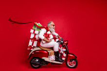 Profile Side View Of His He Nice Attractive Stylish Cheerful Cheery Gray-haired Man Riding Driving Bike Delivering Shop Sale Discount Boxes Isolated Over Bright Vivid Shine Red Background